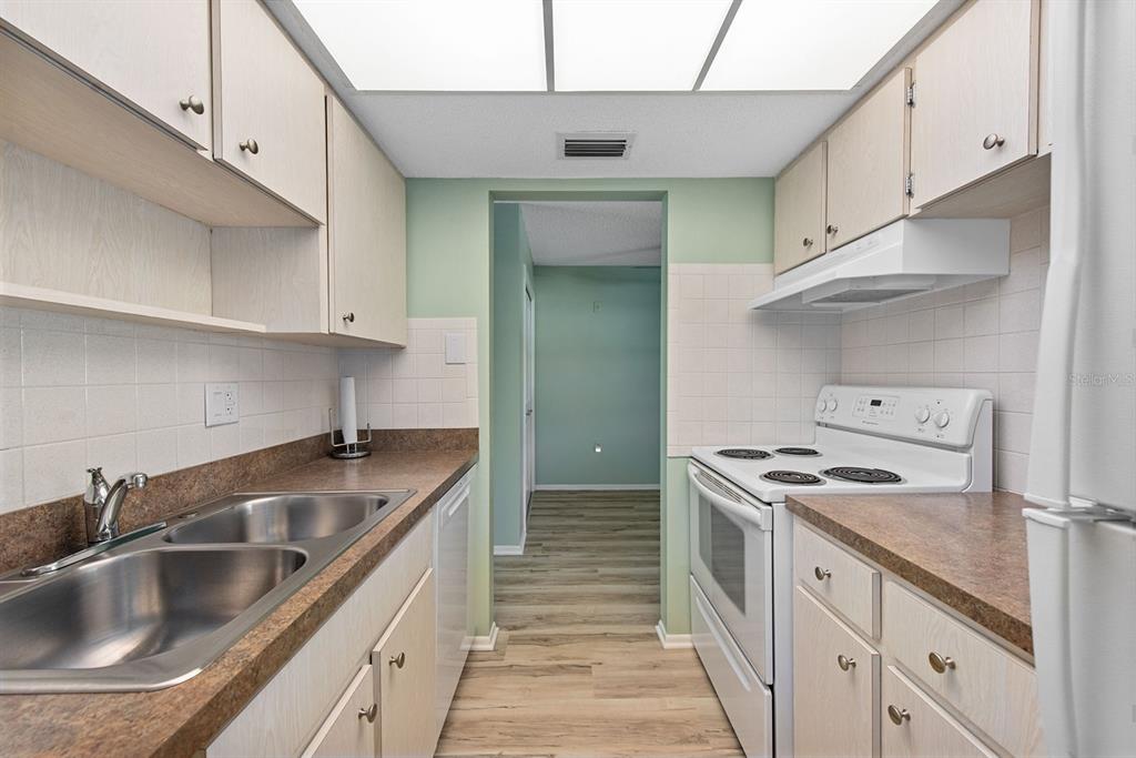 9 Quails Run Boulevard, Unit 9 Englewood, FL 34223 - Photo 12 of 42 a kitchen that has a sink and a stove