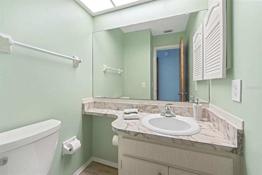 9 Quails Run Boulevard, Unit 9 Englewood, FL 34223 - Photo 13 of 42 a bathroom with a sink toilet and a mirror