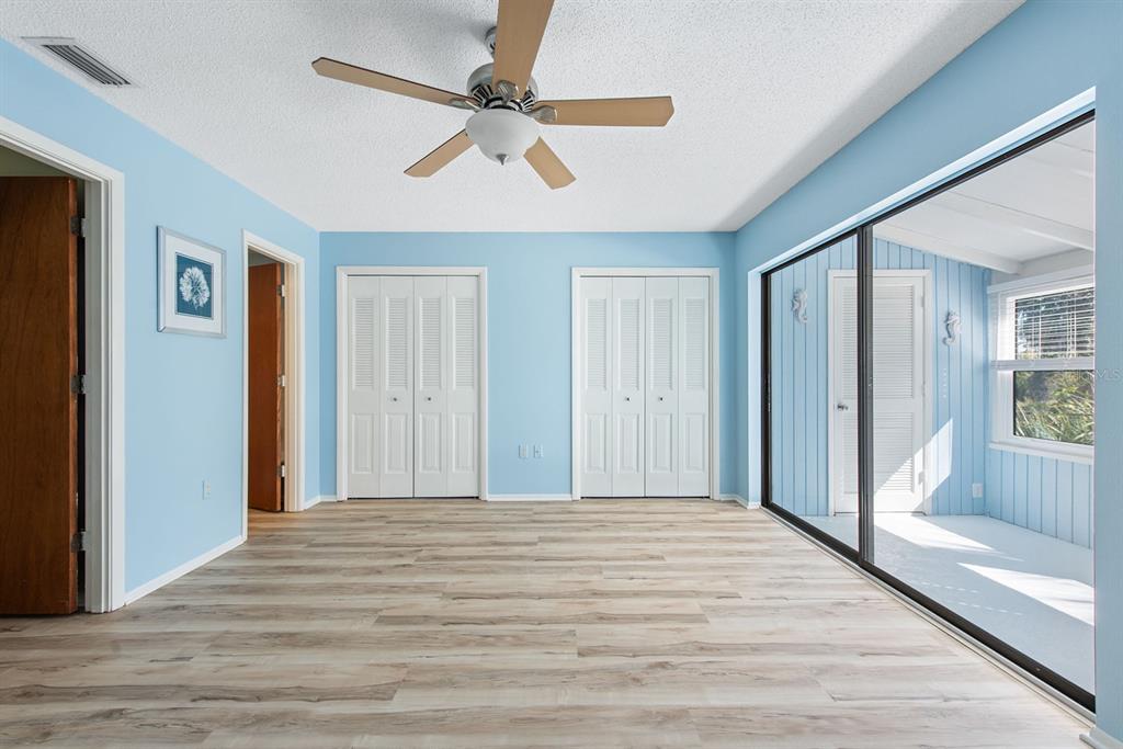 9 Quails Run Boulevard, Unit 9 Englewood, FL 34223 - Photo 16 of 42 a view of a livingroom with wooden floor and a ceiling fan