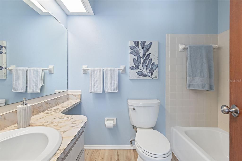 9 Quails Run Boulevard, Unit 9 Englewood, FL 34223 - Photo 18 of 42 a bath room with a toilet a sink and a bath tub