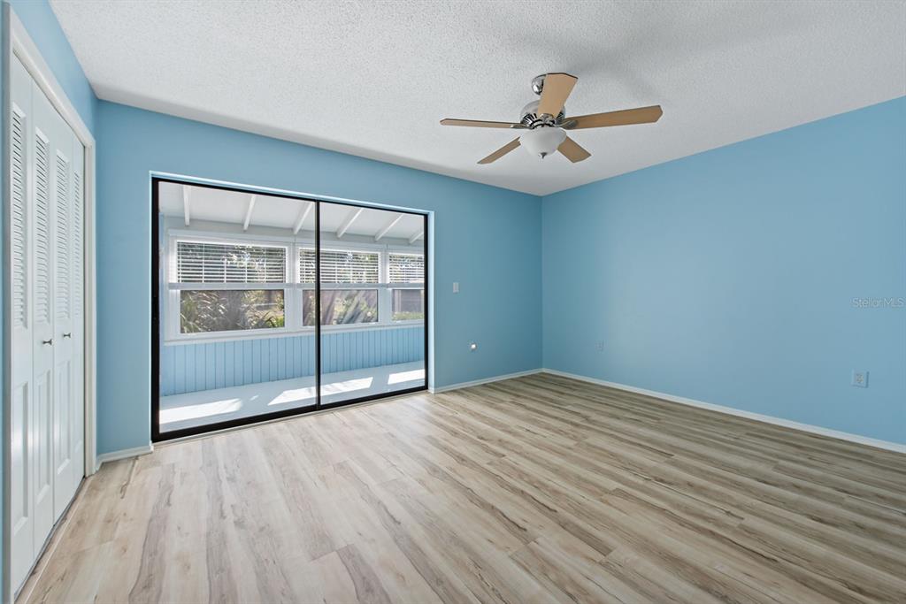 9 Quails Run Boulevard, Unit 9 Englewood, FL 34223 - Photo 21 of 42 an empty room with wooden floor fan and windows