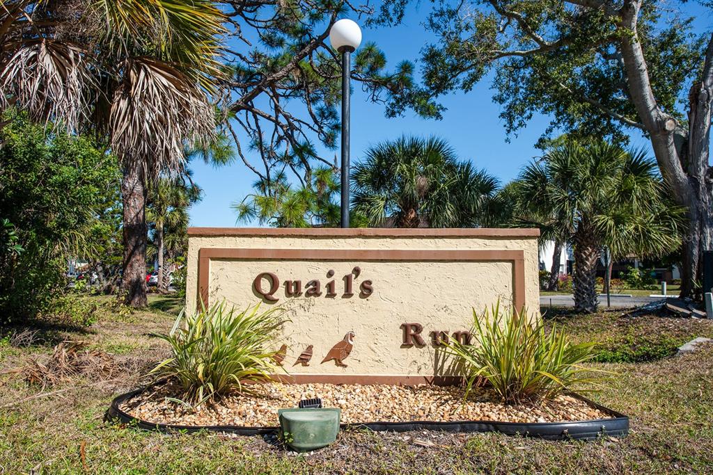 9 Quails Run Boulevard, Unit 9 Englewood, FL 34223 - Photo 30 of 42 a sign that is on the side of the road