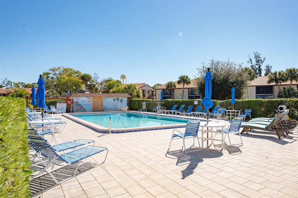 9 Quails Run Boulevard, Unit 9 Englewood, FL 34223 - Photo 32 of 42 a view of a swimming pool with outdoor seating and plants