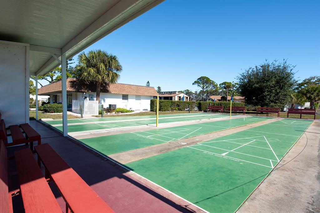 9 Quails Run Boulevard, Unit 9 Englewood, FL 34223 - Photo 33 of 42 a view of a big yard with palm trees