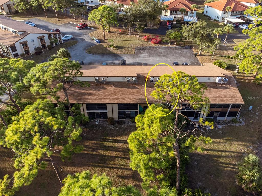 9 Quails Run Boulevard, Unit 9 Englewood, FL 34223 - Photo 39 of 42 an aerial view of a house with swimming pool and large trees