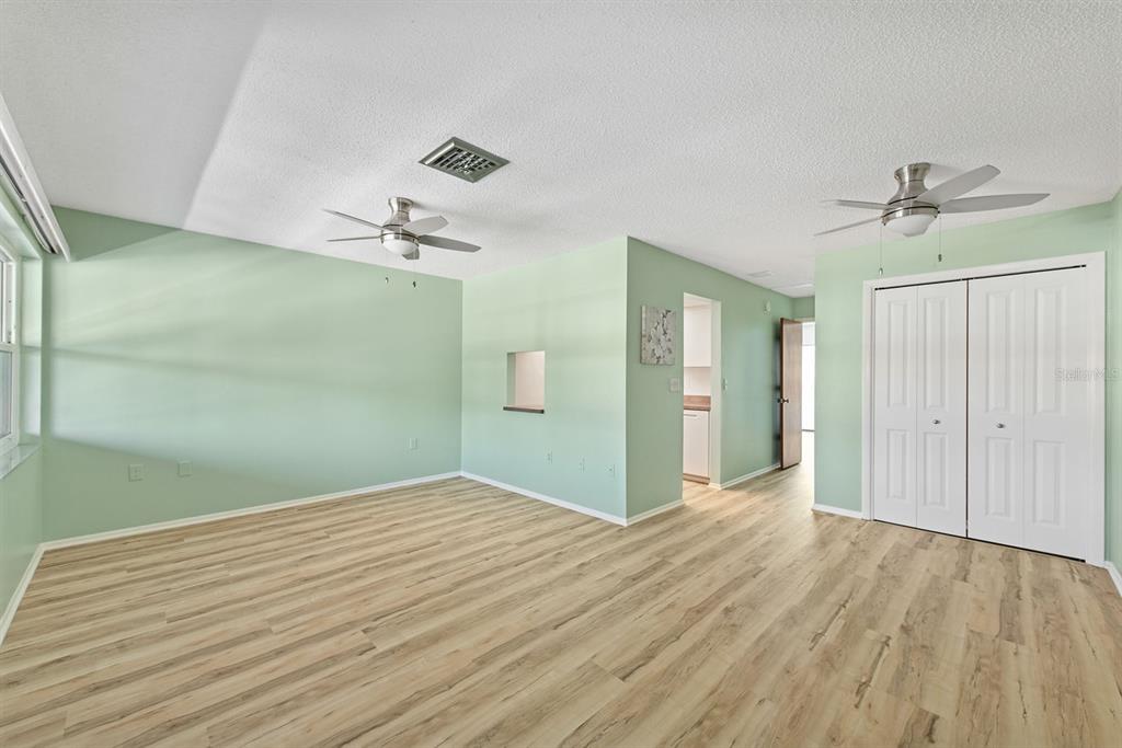 9 Quails Run Boulevard, Unit 9 Englewood, FL 34223 - Photo 4 of 42 a view of a big room with wooden floor and chandelier fan