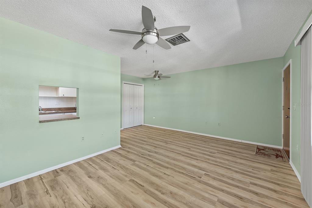 9 Quails Run Boulevard, Unit 9 Englewood, FL 34223 - Photo 7 of 42 an empty room with a fan & a ceiling fan