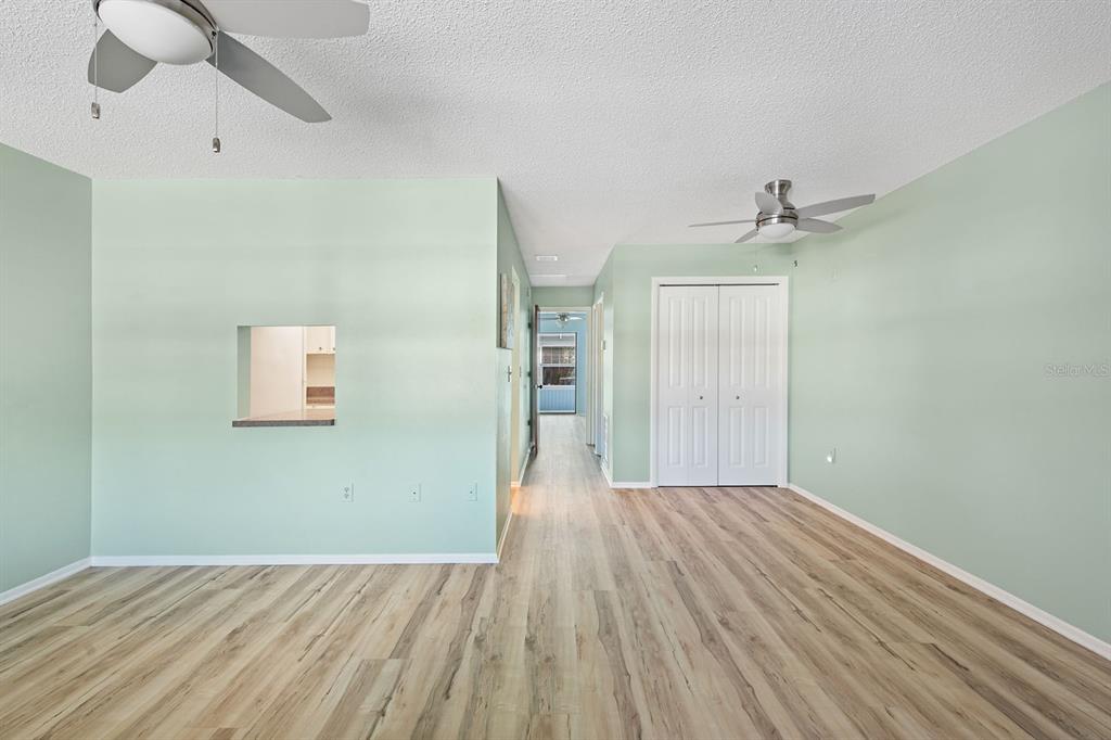 9 Quails Run Boulevard, Unit 9 Englewood, FL 34223 - Photo 8 of 42 wooden floor in an empty room with a window