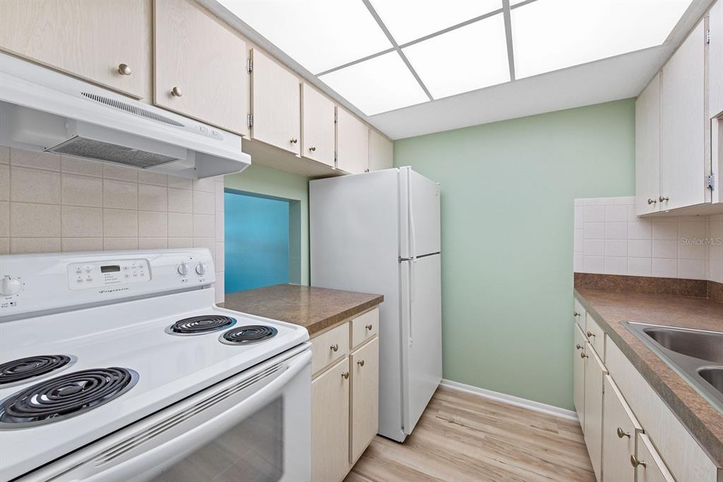 9 Quails Run Boulevard, Unit 9 Englewood, FL 34223 - Photo 10 of 42 a kitchen with a stove and a refrigerator