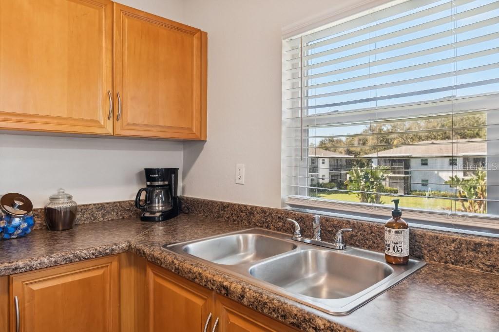 13125 Wilcox Road, Unit 6205 Largo, FL 33774 - Photo 12 of 48 a kitchen with granite countertop a sink and a window