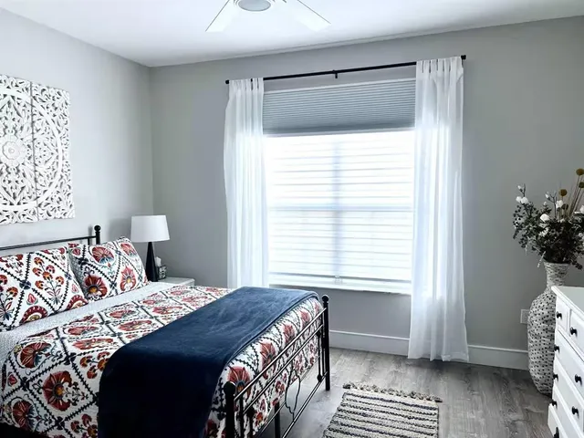 a bedroom with a bed and a window
