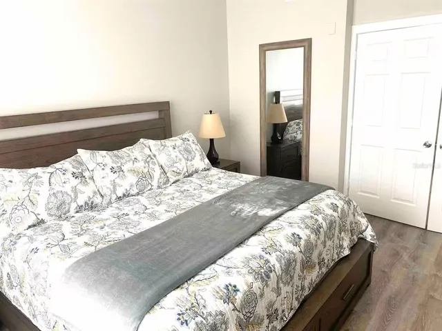 a bedroom with a bed and a mirror