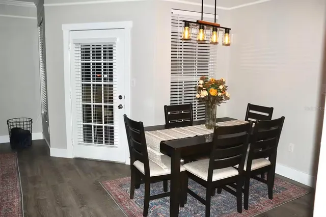 a view of a dining room with furniture and window