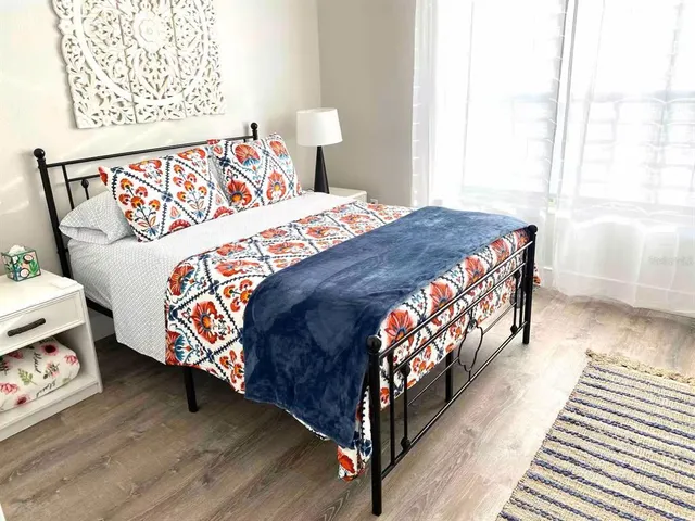 a bedroom with a bed and a window