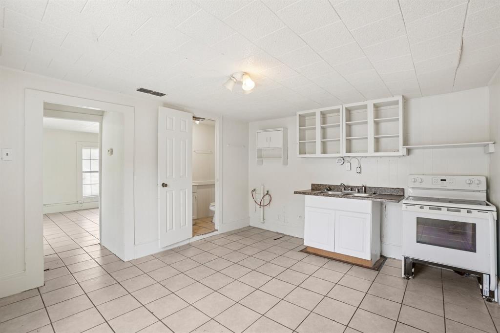 a kitchen with granite countertop white cabinets and white appliances