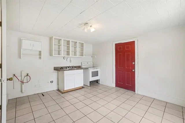 a kitchen with a stove a sink and a refrigerator