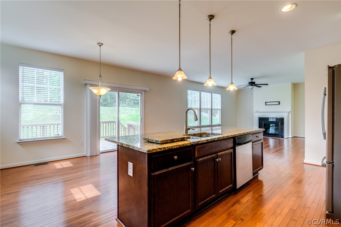 14513 Needham Market Road Midlothian, VA 23112 - Photo 11 of 31 a kitchen with stainless steel appliances granite countertop wooden floors sink and cabinets