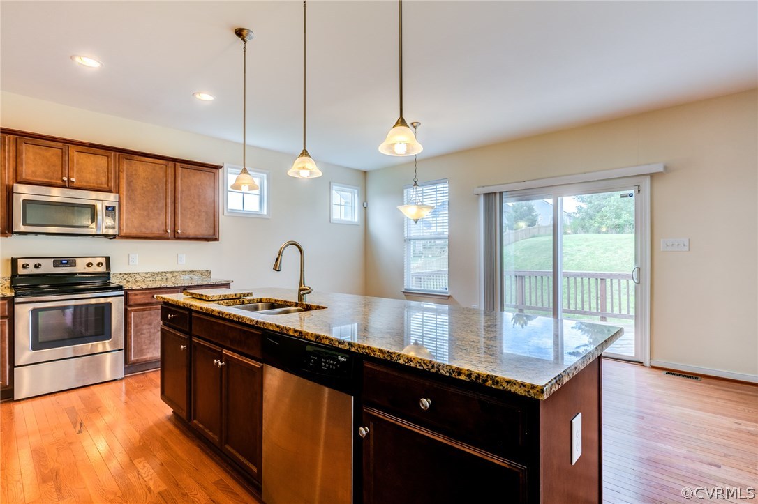 14513 Needham Market Road Midlothian, VA 23112 - Photo 13 of 31 a kitchen with granite countertop a sink a counter space appliances and cabinets