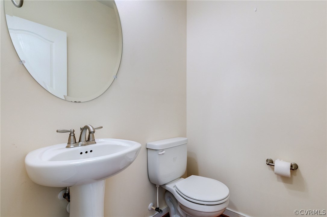 14513 Needham Market Road Midlothian, VA 23112 - Photo 16 of 31 a bathroom with a sink a mirror and a toilet