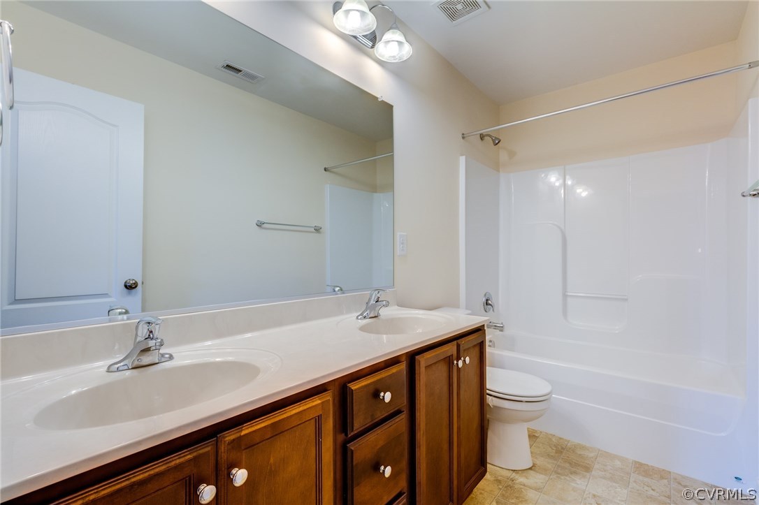 14513 Needham Market Road Midlothian, VA 23112 - Photo 17 of 31 a bathroom with a sink a toilet a mirror and shower
