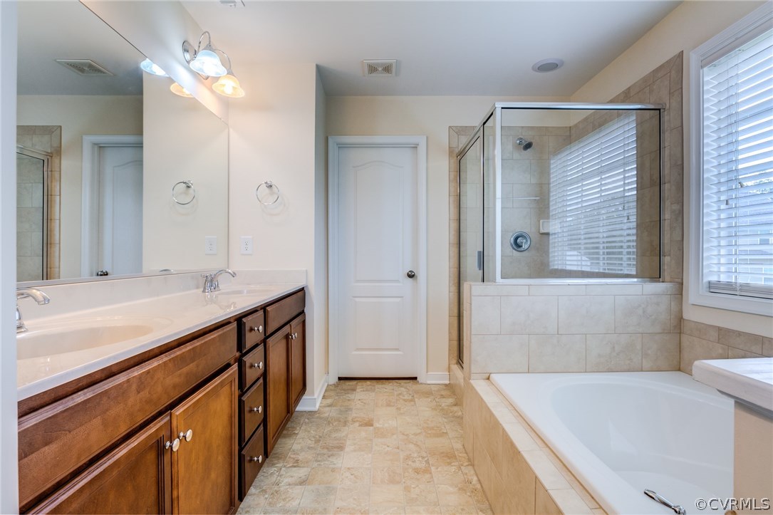 14513 Needham Market Road Midlothian, VA 23112 - Photo 22 of 31 a bathroom with a tub a sink and a shower