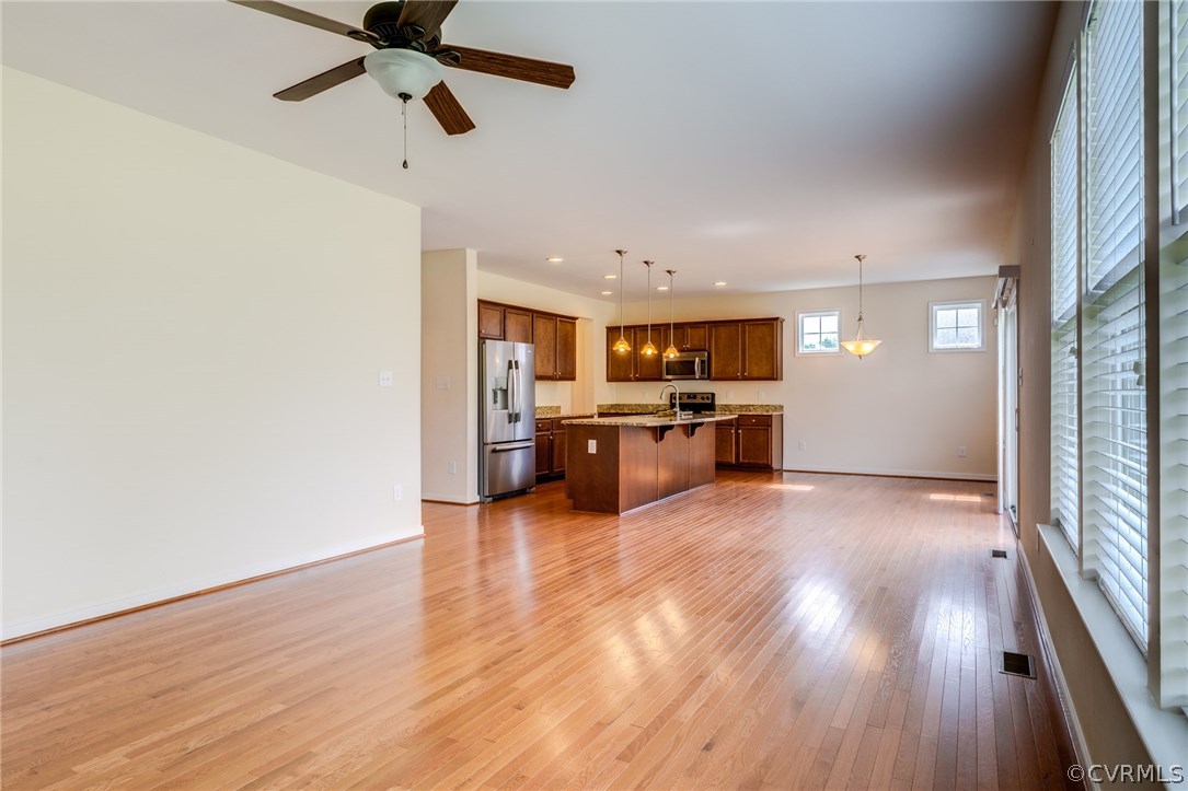 14513 Needham Market Road Midlothian, VA 23112 - Photo 5 of 31 a view of open kitchen with wooden floor electronic appliances and window