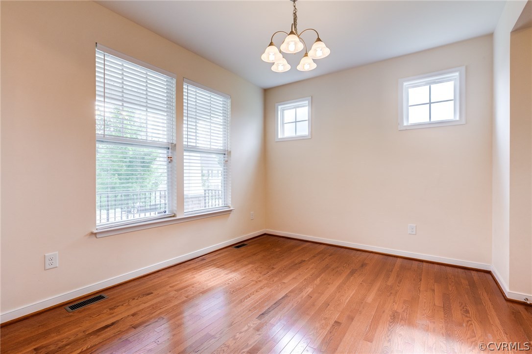 14513 Needham Market Road Midlothian, VA 23112 - Photo 6 of 31 a view of an empty room with wooden floor and a window