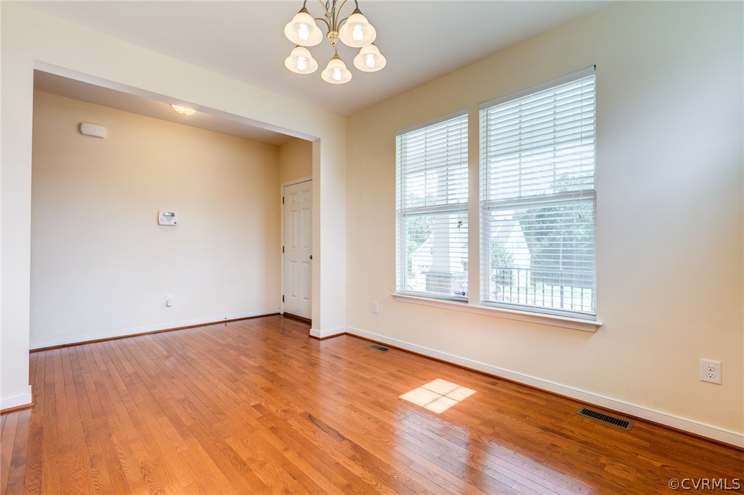14513 Needham Market Road Midlothian, VA 23112 - Photo 7 of 31 a view of an empty room with a window and wooden floor