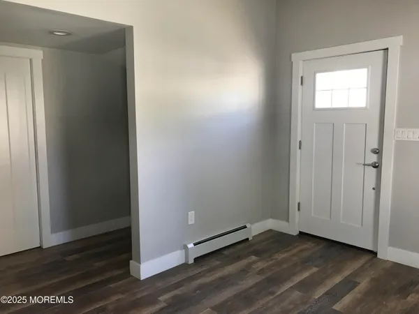 an empty room with wooden floor