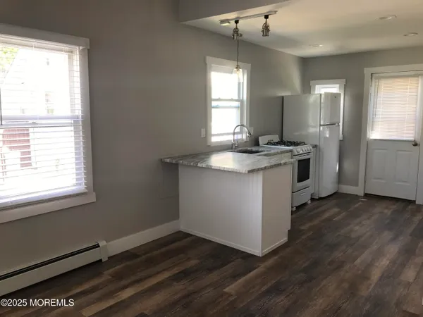 a kitchen with a sink stove and cabinets