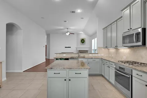 a kitchen with a sink stove and microwave