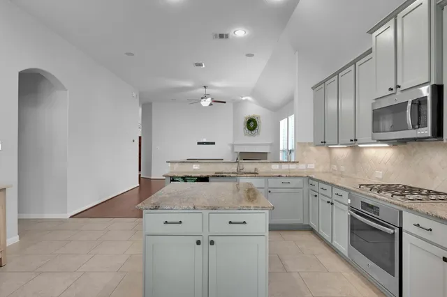 a kitchen with a sink stove and microwave