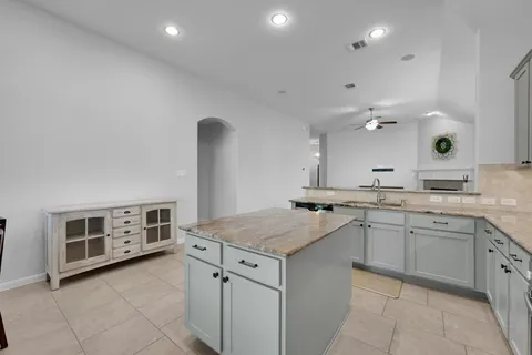 a kitchen with a sink stove and cabinets