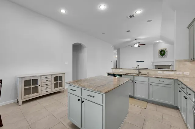 a kitchen with a sink stove and cabinets