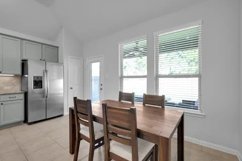 a view of a dining room with furniture and window