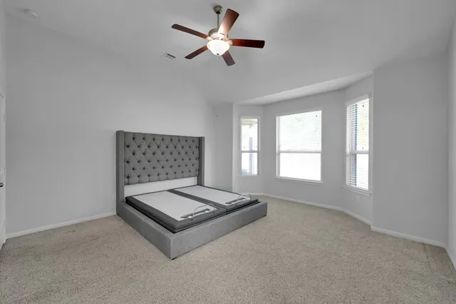 a living room with furniture and a ceiling fan
