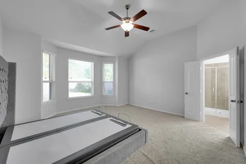 a room with furniture and a ceiling fan