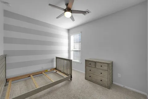 a living room with a furniture and a ceiling fan