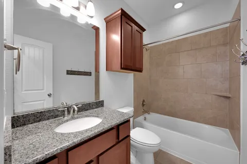a view of a hallway with wooden floor windows and a mirror