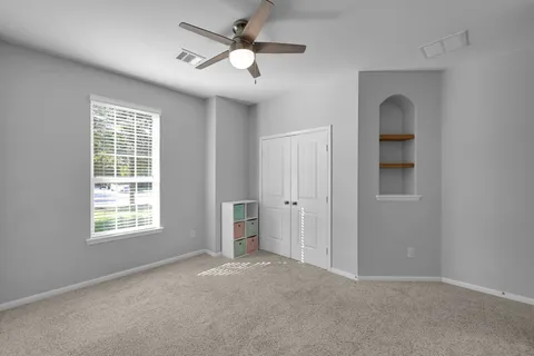 a view of storage and utility room with closet