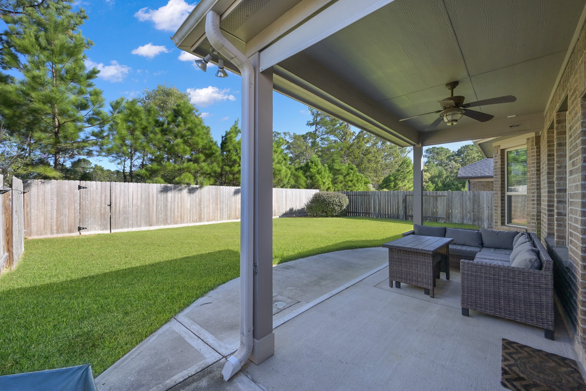 31851 Chapel Rock Lane Spring, TX 77386 - Photo 35 of 50 a view of a patio with couches chairs and a yard