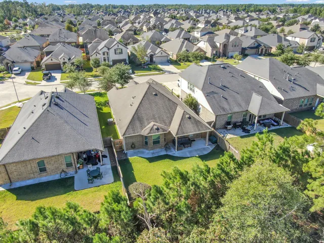 an aerial view of residential houses with outdoor space and swimming pool