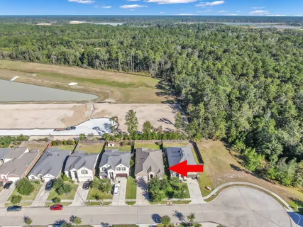 a living room with patio furniture and a garden