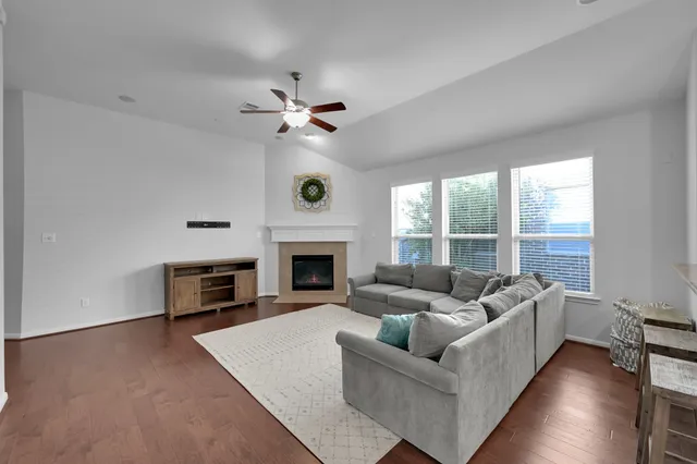 a living room with furniture a fireplace and a large window