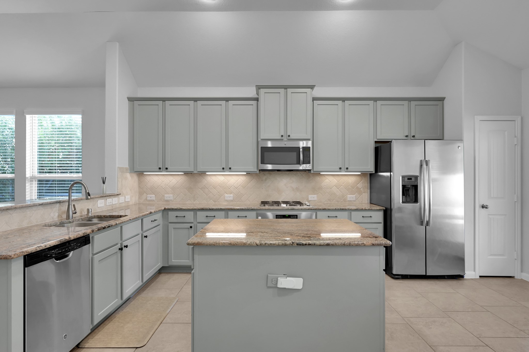 31851 Chapel Rock Lane Spring, TX 77386 - Photo 10 of 50 a kitchen with stainless steel appliances granite countertop a sink a stove a refrigerator and a granite counter tops