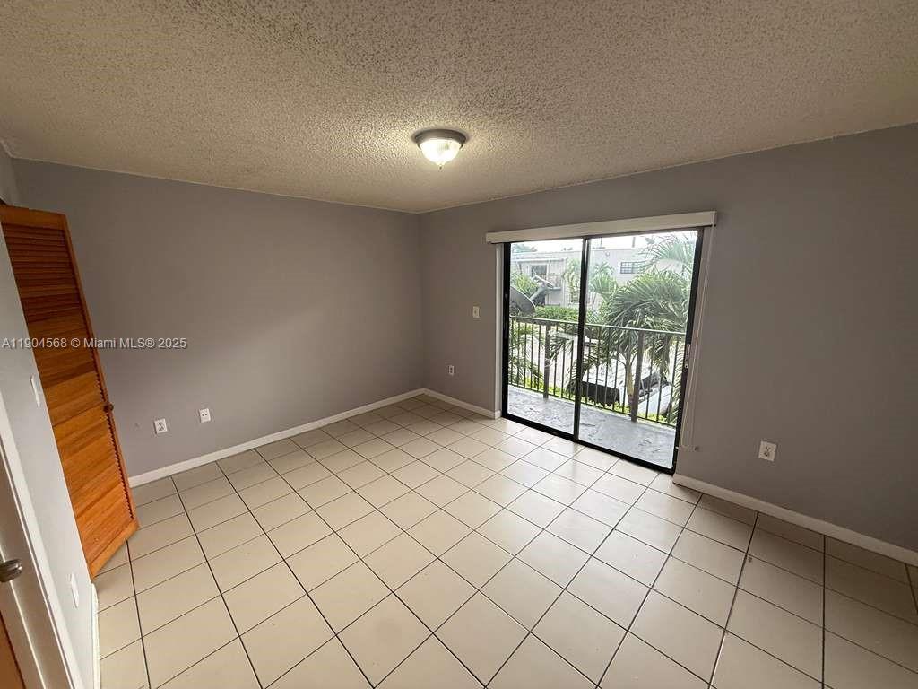 335 West 68th Street, Unit 201 Hialeah, FL 33014 - Photo 3 of 8 a view of an empty room and window