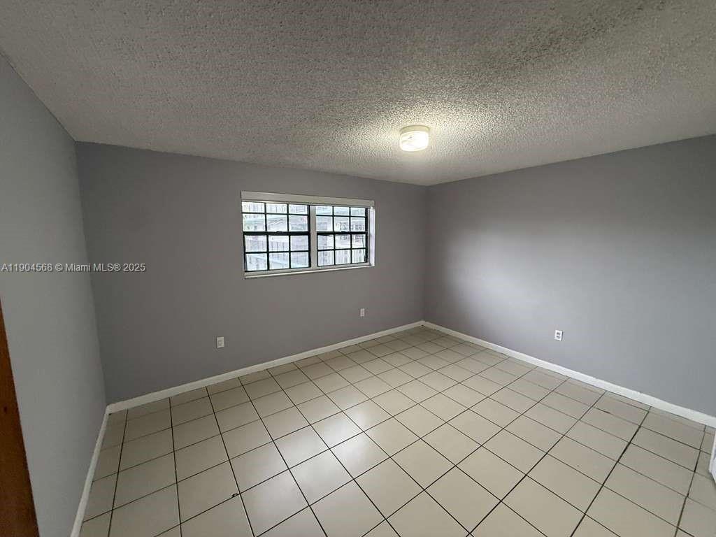 335 West 68th Street, Unit 201 Hialeah, FL 33014 - Photo 4 of 8 a view of an empty room and window