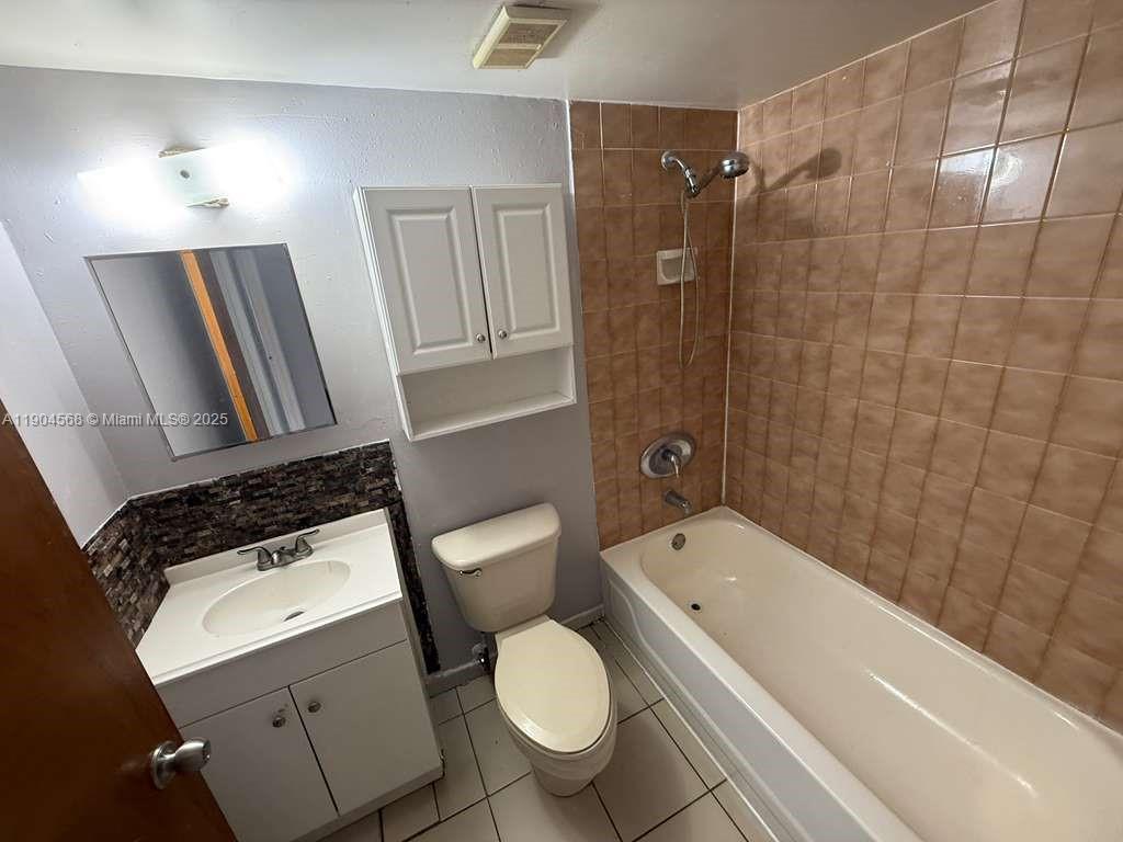 335 West 68th Street, Unit 201 Hialeah, FL 33014 - Photo 5 of 8 a bathroom with a toilet a sink and bathtub