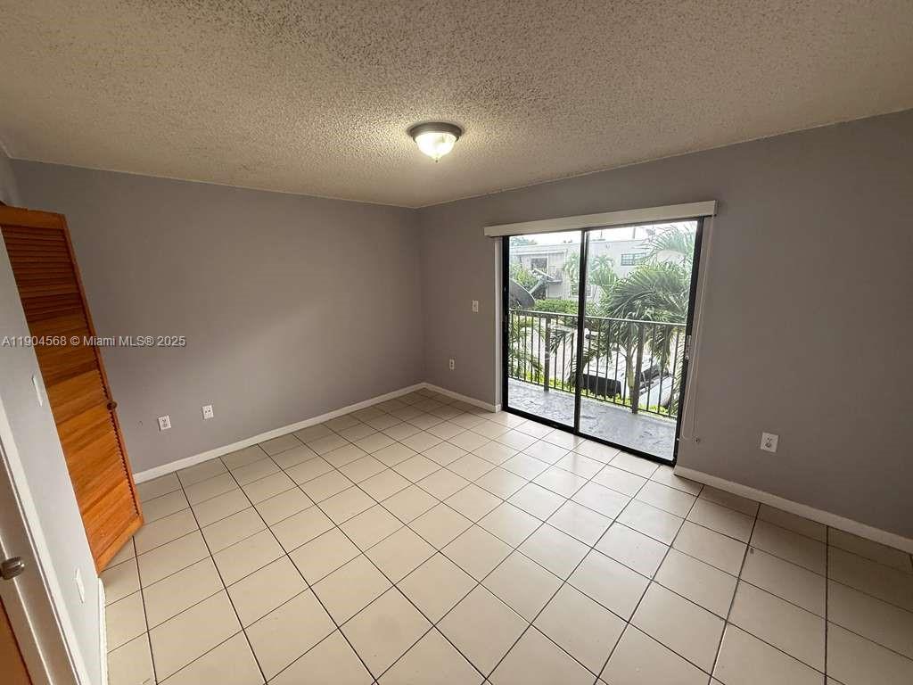 335 West 68th Street, Unit 201 Hialeah, FL 33014 - Photo 6 of 8 a view of an empty room and window
