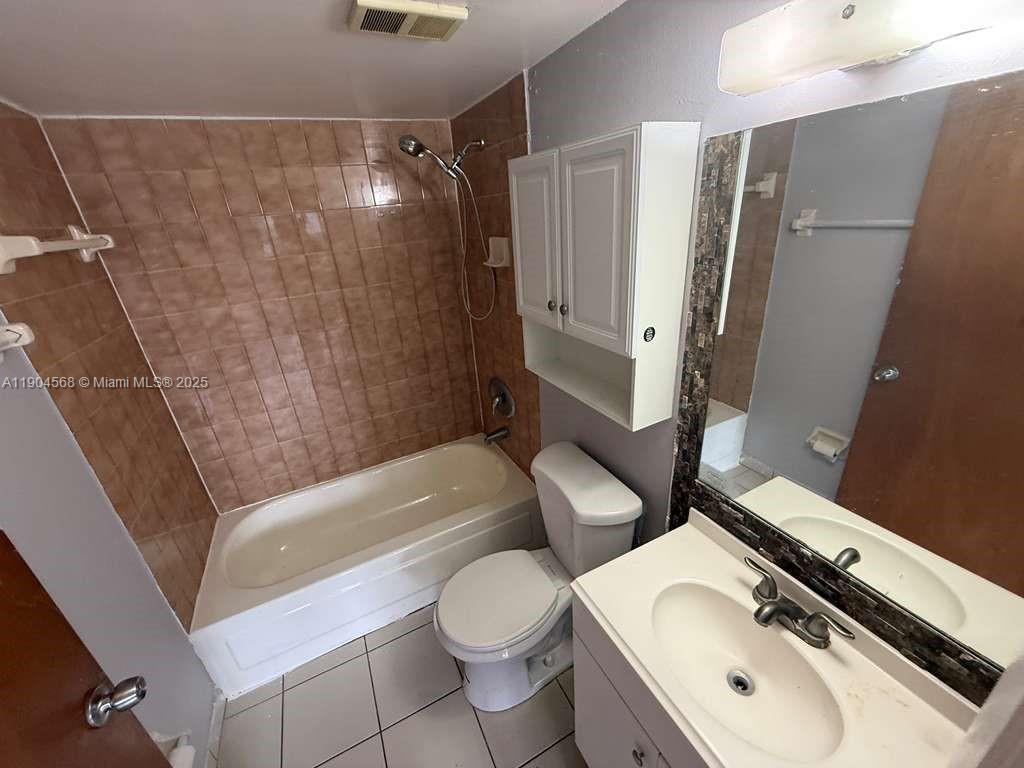 335 West 68th Street, Unit 201 Hialeah, FL 33014 - Photo 8 of 8 a bathroom with a sink a toilet and shower